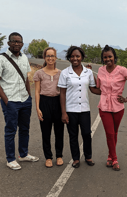 Photo of four young people standing in the road
