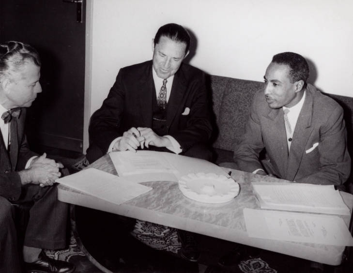 Historical black and white photo of the signing of the Educational Exchange agreement between the United States and Ethiopia, 1961.