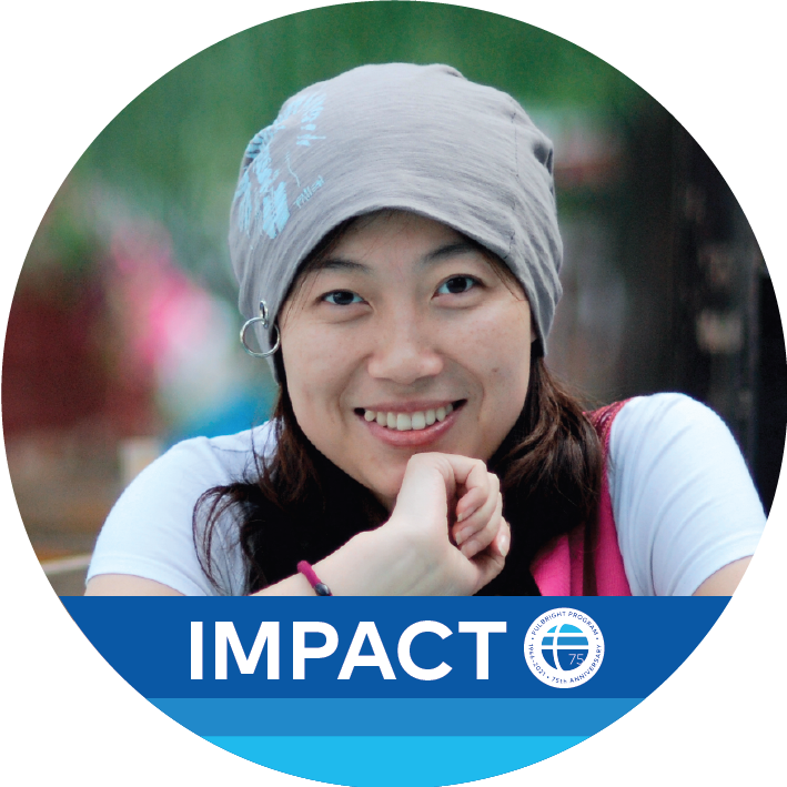 Round photo of a woman with three blue lines at the bottom with the word "Impact" and the Fulbright globe next to it