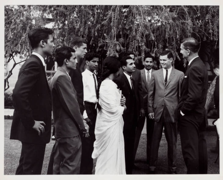 Historical black and white photo of U.S. Ambassador to Pakistan Walter P. McConaughy speaking to a group of local Pakistani students.