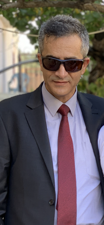 Photo of a man in a suit wearing sunglasses