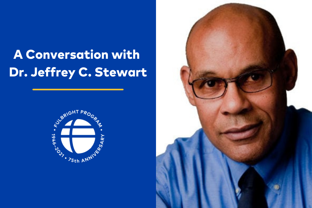 Photo of a bald person with glasses, a tie, and a blue button-down. White text reads: A conversation with Dr. Jeffrey C. Stewart.